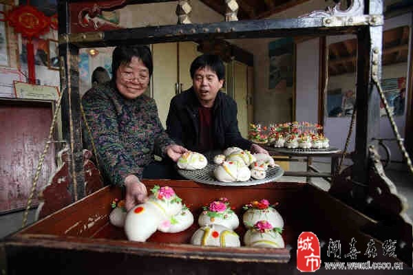 1月15日,闻喜县副县长杨云英、文化馆馆长支建康,来到阳隅乡回坑村村民杨婷枝家。走进杨婷枝家的东房,映入眼帘的是刚刚捏好的精美花馍。 上午10时许,该村两个村民抬着食盒来取为孩子过12岁生日订做的花馍,杨婷枝细心地把整个食盒用毛巾擦洗了一遍,小心翼翼地将花馍装进食盒里。 据了解,闻喜花馍是该县历代妇女集体智慧的结晶,如今已成为一种品牌和产业。在一些地方,一个人从出生到满月、周岁、订婚、结婚、做寿,一直到人生终结,每一个环节都要用花馍来体现文化品位;一年12个月,每个月都有节气,从春节、元宵节,到二月二龙抬